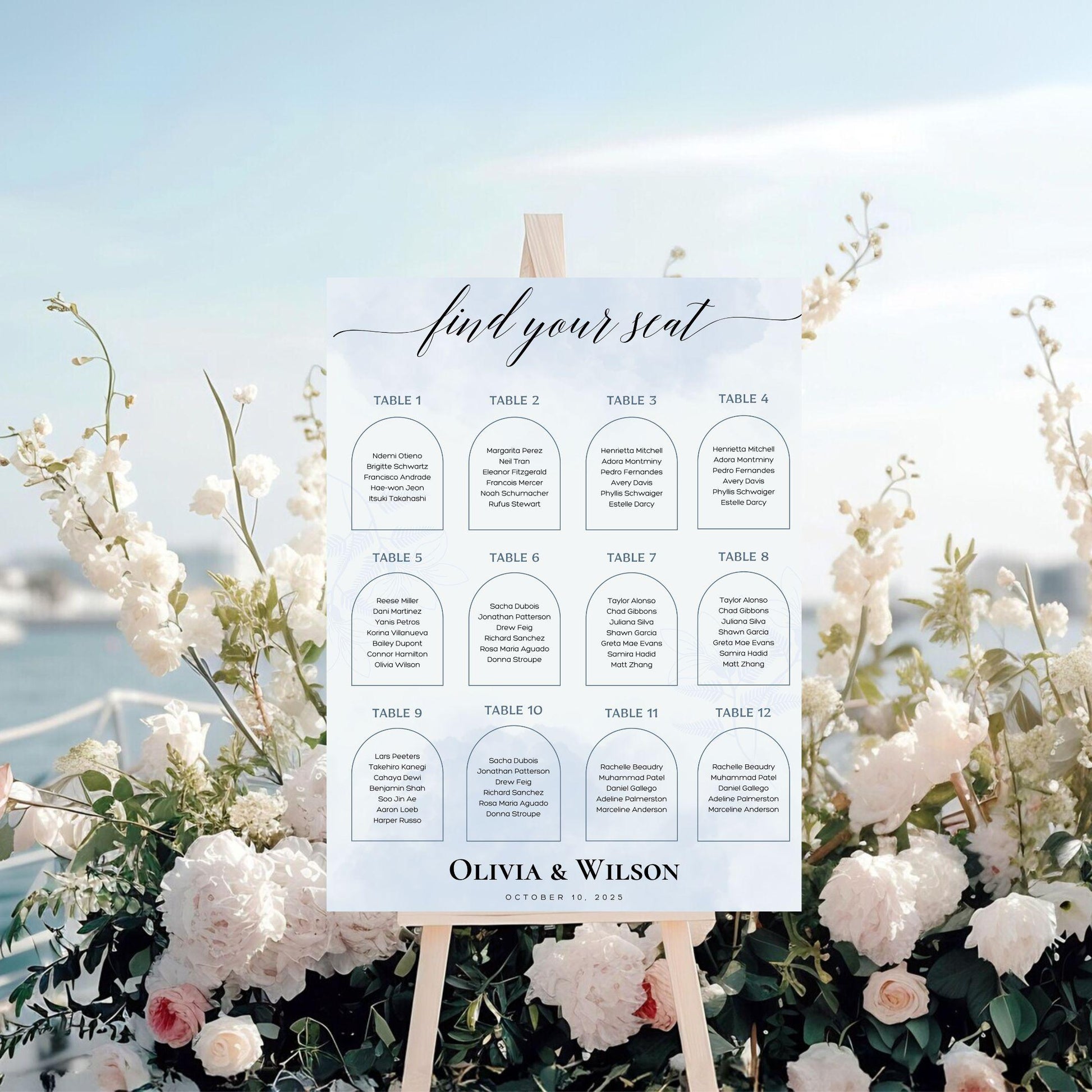 Elegant wedding seating chart template by ProCardist displayed on easel with floral decor and ocean background
